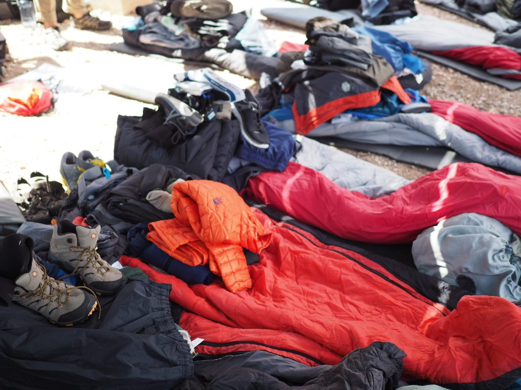 Backpacking gear organized on the ground